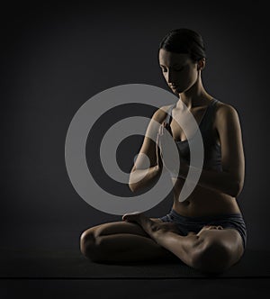 Yoga woman meditate sitting in lotus pose. Silhoue