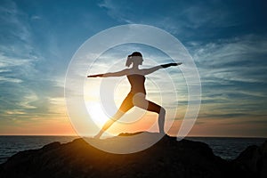 Yoga woman meditating in Assane the Warrior position.