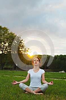 Yoga woman meditating and making a zen symbol with her hand in lotus pose.