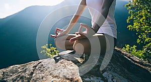 Yoga woman meditating on mountain photo