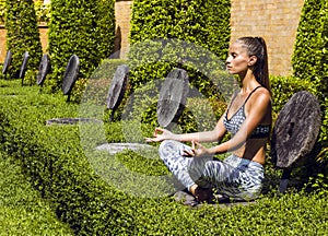 Yoga woman poses in tropics wearing stylish