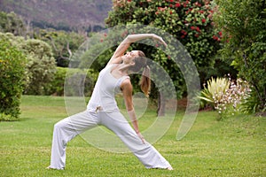 Yoga woman practising outside in park