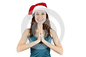 Yoga woman with santa claus hat in namaste pose