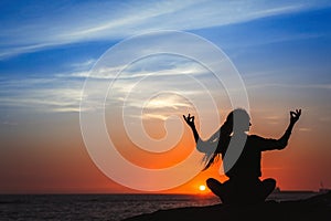 Yoga woman silhouette series. Meditation during amazing sunset.