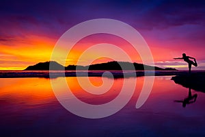 Yoga Woman at Sunrise on the Beach