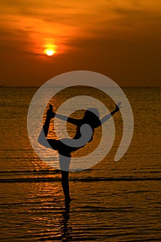 Yoga women silhouette at sunset