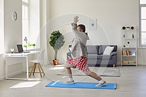 Yoga work at home. Funny fat man practices yoga meditation while sitting on the floor in the room online at home.