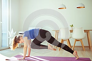 Yoga workout in selfisolation at home due to coronavirus quarantine photo