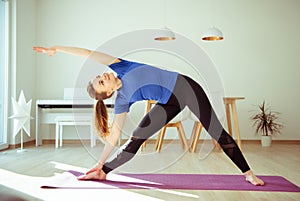 Yoga workout in selfisolation at home due to coronavirus quarantine photo