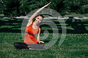 Yoga. Young woman practicing yoga meditation in nature a park. Health lifestyle concept