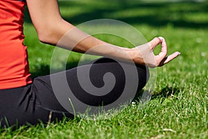 Yoga. Young woman practicing yoga meditation in nature a park. lotus posture. Health lifestyle concept