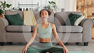 Yoga, zen and woman on living room floor to relax, breath and meditate at home. Health, fitness and spiritual wellness