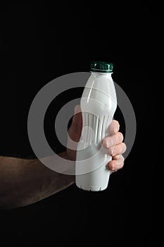 Yoghurt bottle with healthy drink in hand of man