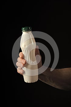 Yoghurt bottle with healthy drink in hand of man