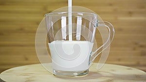 Yoghurt is poured into glass mug.