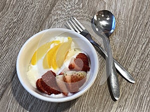 Yoghurt with strawberry and pear slices photo