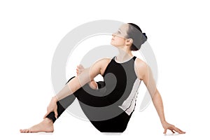 Yogi athlete girl in yoga asana parivritta Eka Pada Agnistambhasana