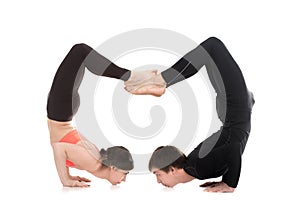 Yogi couple in yoga fierce bird pose photo