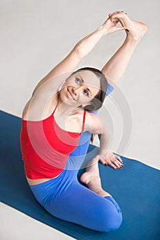 Yogi Girl Sitting in Parivrtta Surya Yantrasana Pose