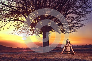 Yogi man meditating at sunset on the hills. Lifestyle relaxation emotional concept spirituality harmony with nature photo