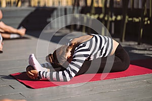 Yogi woman and diverse group of sporty people practicing yoga