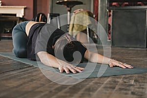 yogi woman resting in child pose in her vinyasa flow yoga practice alone