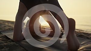 Yogi woman standing head practicing shirshasana summer evening close up.