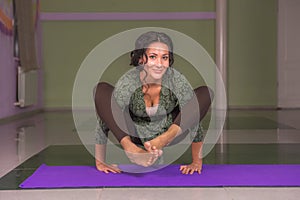 Yogi woman working out in yoga in a studio