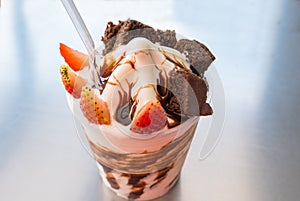 Yogur with chocolate cream strawberries and chocolate cake photo