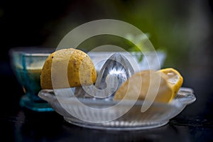 Yogurt face pack with raw lemon juice,honey and turmeric powder and yogurt or curd in a glass bowl on wooden surface,Close up view