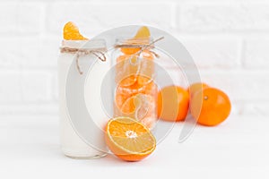 Yogurt with fresh orange slices and whole oranges