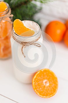 Yogurt with fresh orange slices and whole oranges