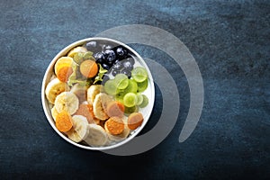 Yogurt with fruits, grapes, physalis, bananas and blueberries