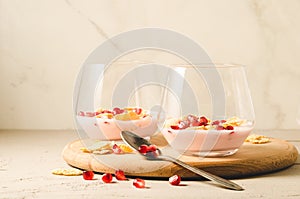 yogurt with garnet grains and flakes in glass/yogurt with garnet grains and flakes in glass on a wooden tray and white background