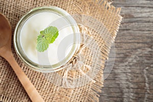 Yogurt in glass bottles on old wooden table