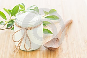 Yogurt in glass bottles on white wooden table Healthy food concept