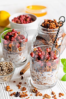 Yogurt with granola and berries in glasses