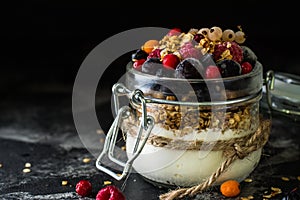 Yogurt with granola and berries in small jar, strawberries, blueberries., black currant. sweetness. Homemade yogurt. Healthy food