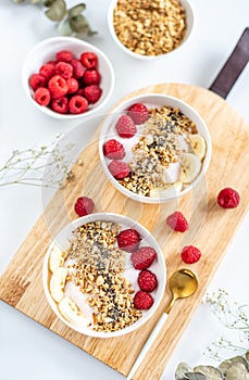 Yogurt with granola, chia seed, raspberry and banana