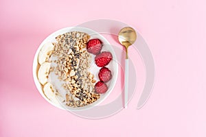 Yogurt with granola, chia seed, raspberry and banana, healthy breakfast concept