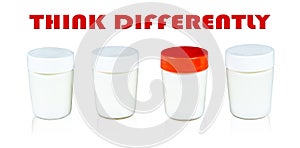 Yogurt jar with red lid between jars with white lids. Motivational quote Think Differently.
