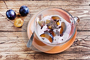 Yogurt with muesli and berries in small glass