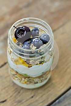 Yogurt oat granola with blueberries, orange, kiwi and cherry in