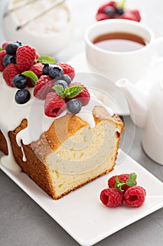 Yogurt pound cake with glaze and fresh berries