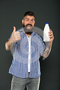 Yogurt probiotics and prebiotics. Bearded man hold white bottle with milk. Brutal caucasian hipster drink milk. Lactose photo