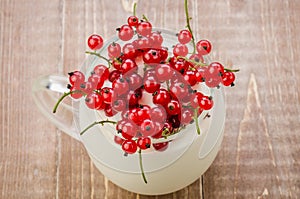 Yogurt with red currant in glass/yogurt with red currant in glass on a wooden background. Top view