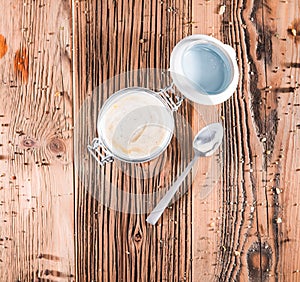 Yogurt, sour cream bowl on wooden board