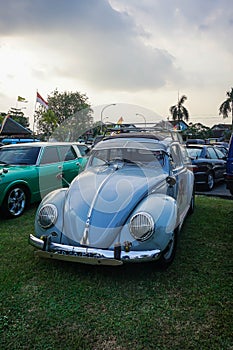 Blue Volkswagen Beetle on parking lot