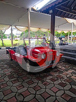 Red Mini Moke in a classic car show