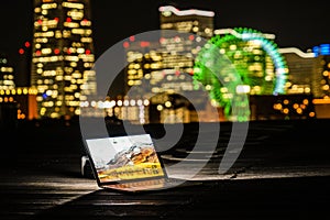 Yokohama night view and a laptop Nomad worker of the image